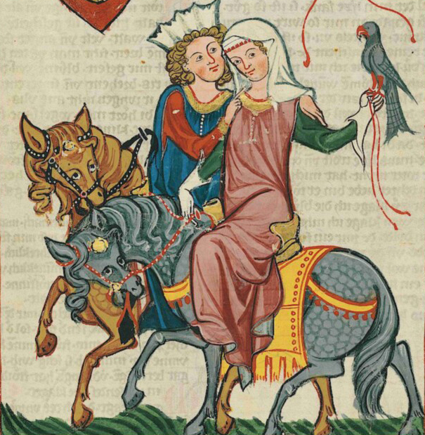 A man and woman on horseback together. The woman holds a bird of prey.