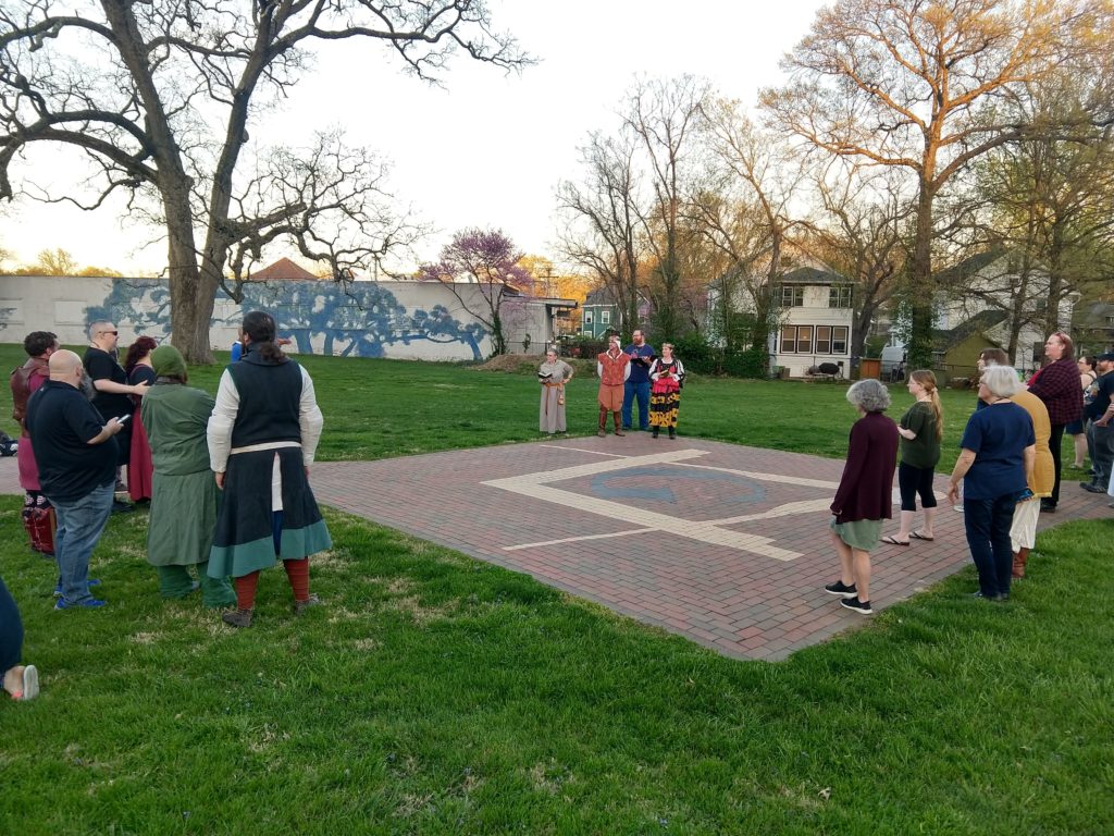 Image of the populace assembled to hear weekly announcements.