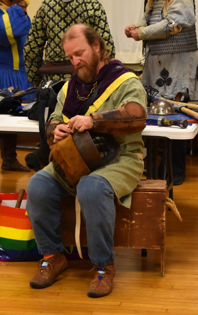 Duncan repairs his helmet.